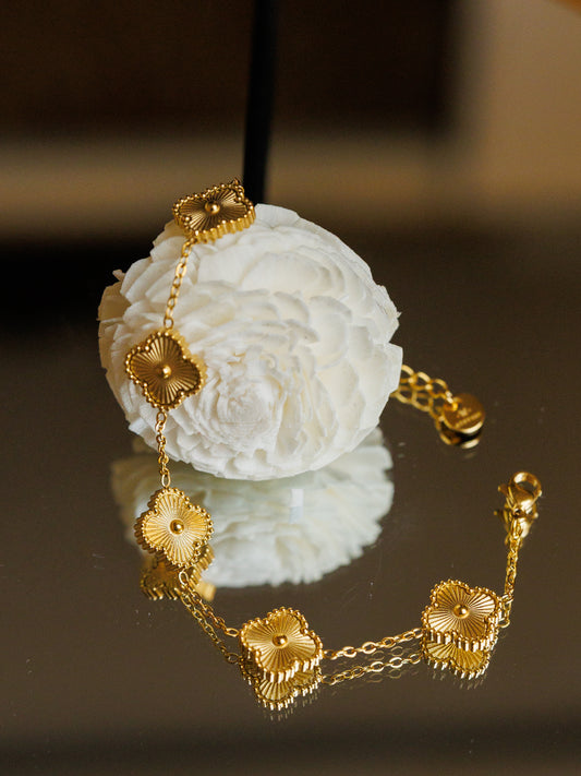 Dare to stand out with our wholesale fine four-leaf clover bracelet in stainless steel, featuring 5 lucky clovers in a bold and daring gold color!
