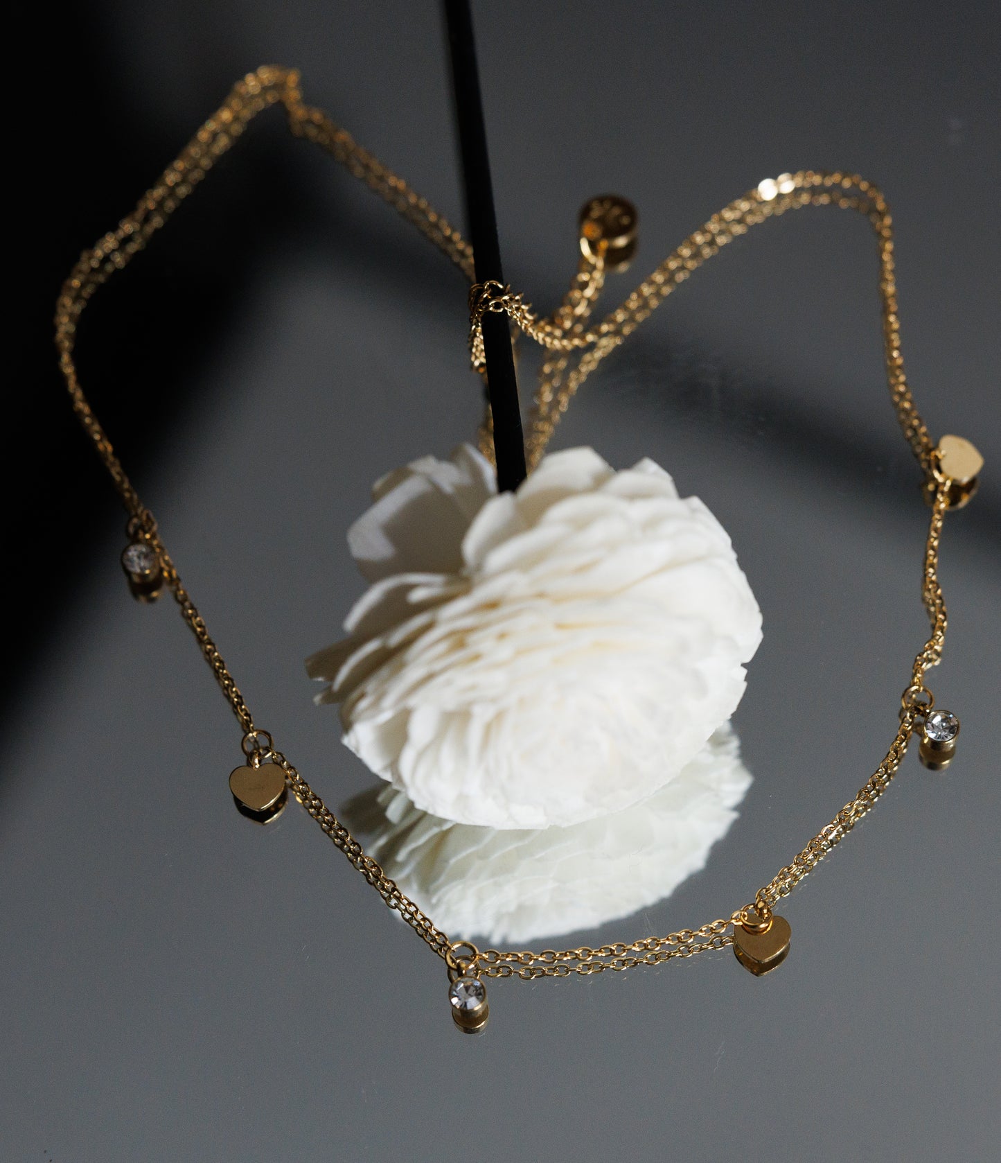 Crafted using top-grade materials, this stainless steel necklace features a charming tassel and intricate zircon heart pendant.