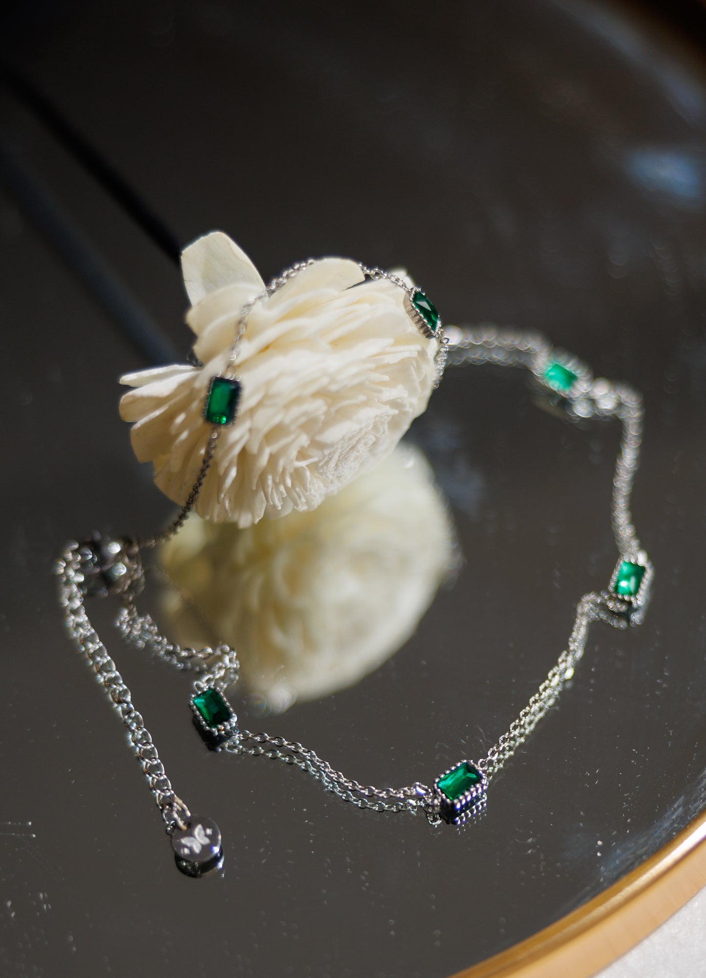 Indulge in luxury with our trendy stainless steel emerald choker necklace. Made with brilliant cubic zirconia stones, this necklace exudes elegance and sophistication.