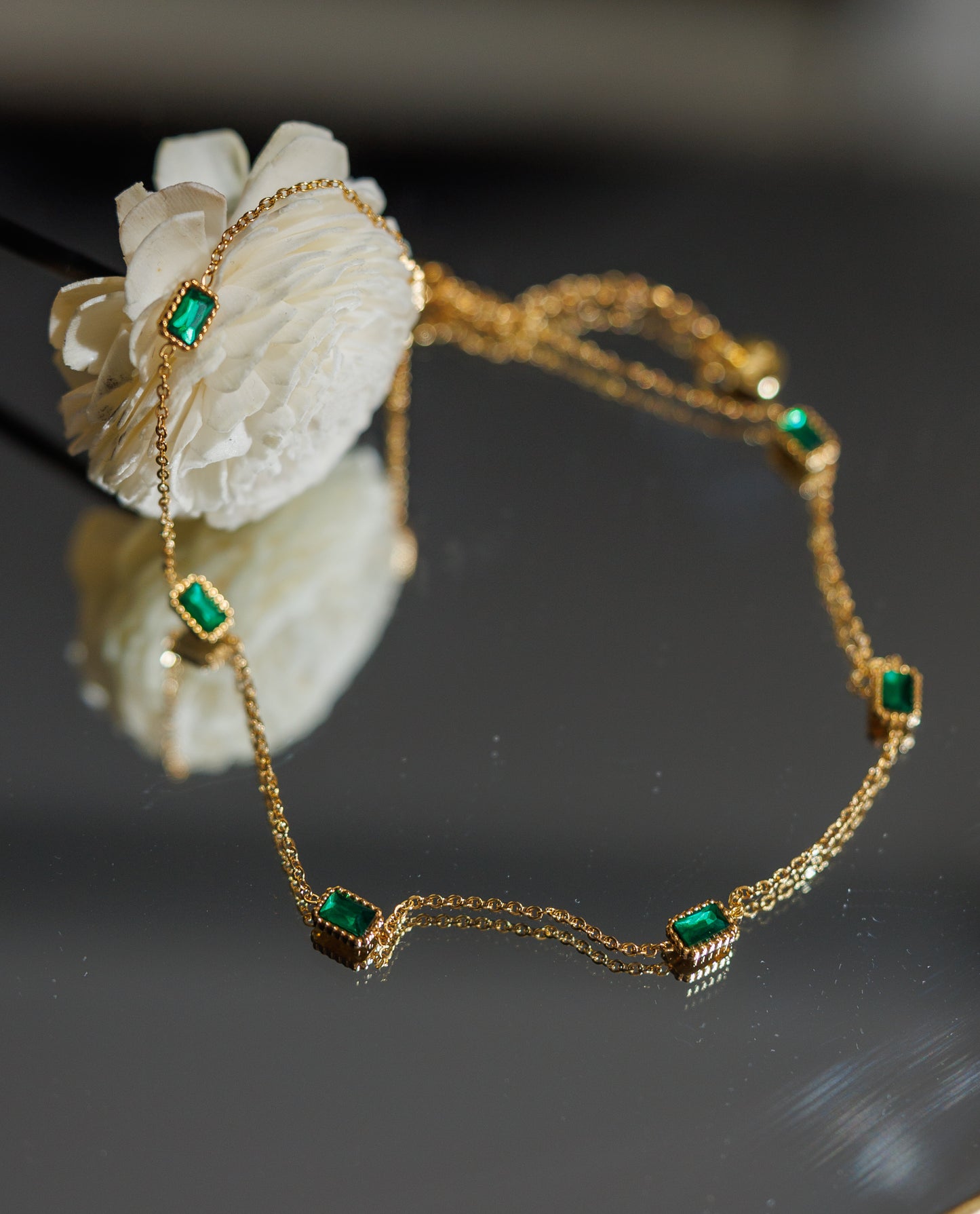 Indulge in luxury with our trendy stainless steel 18k gold plated emerald choker necklace. Made with brilliant cubic zirconia stones, this necklace exudes elegance and sophistication.