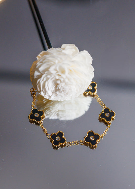 Dare to stand out with our wholesale fine four-leaf clover bracelet in stainless steel, featuring 5 lucky clovers in a bold and daring black color!