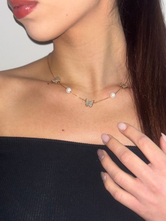 Round pearl necklace features an elegant butterfly design.