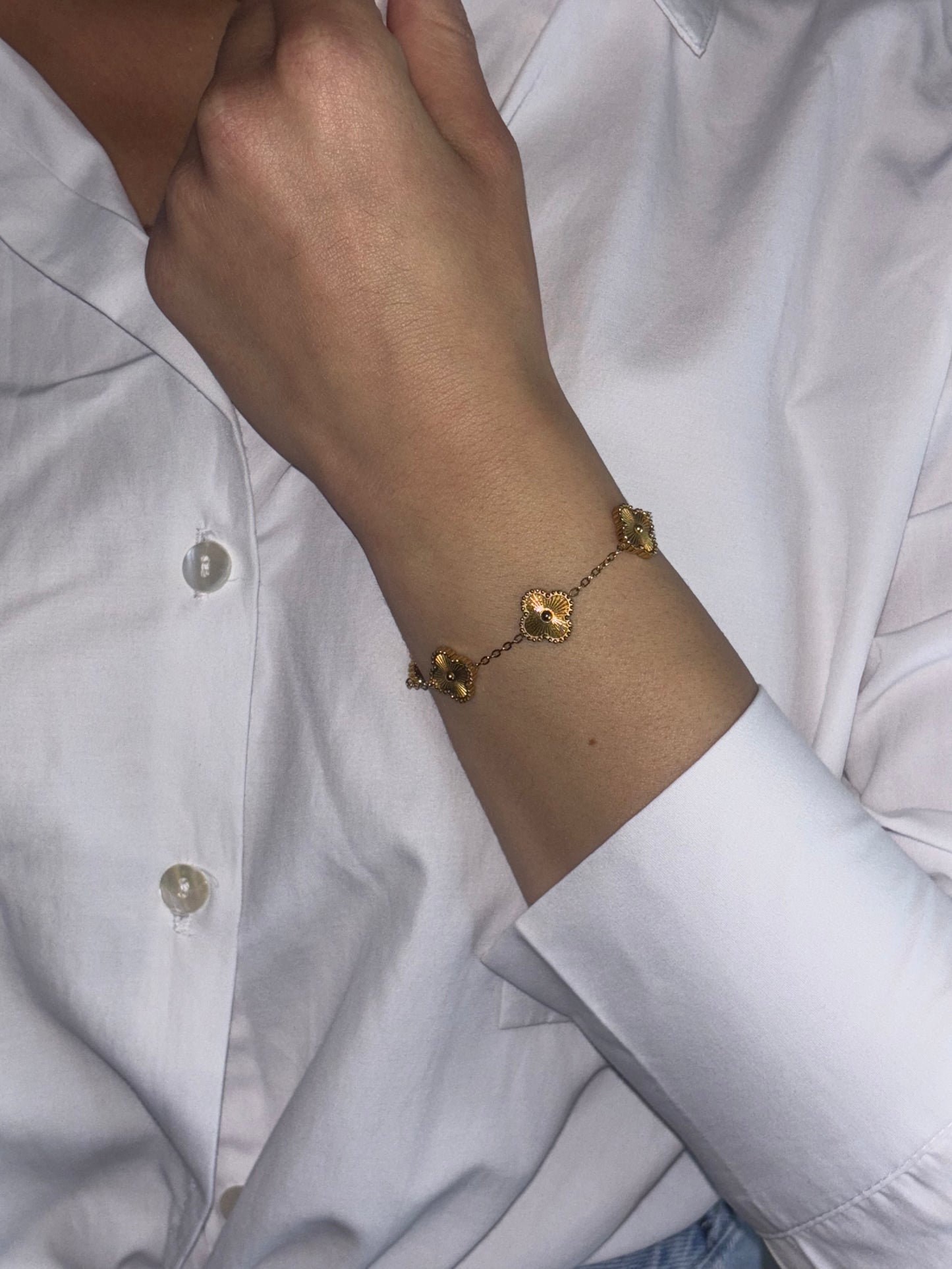 Dare to stand out with our wholesale fine four-leaf clover bracelet in stainless steel, featuring 5 lucky clovers in a bold and daring gold color!
