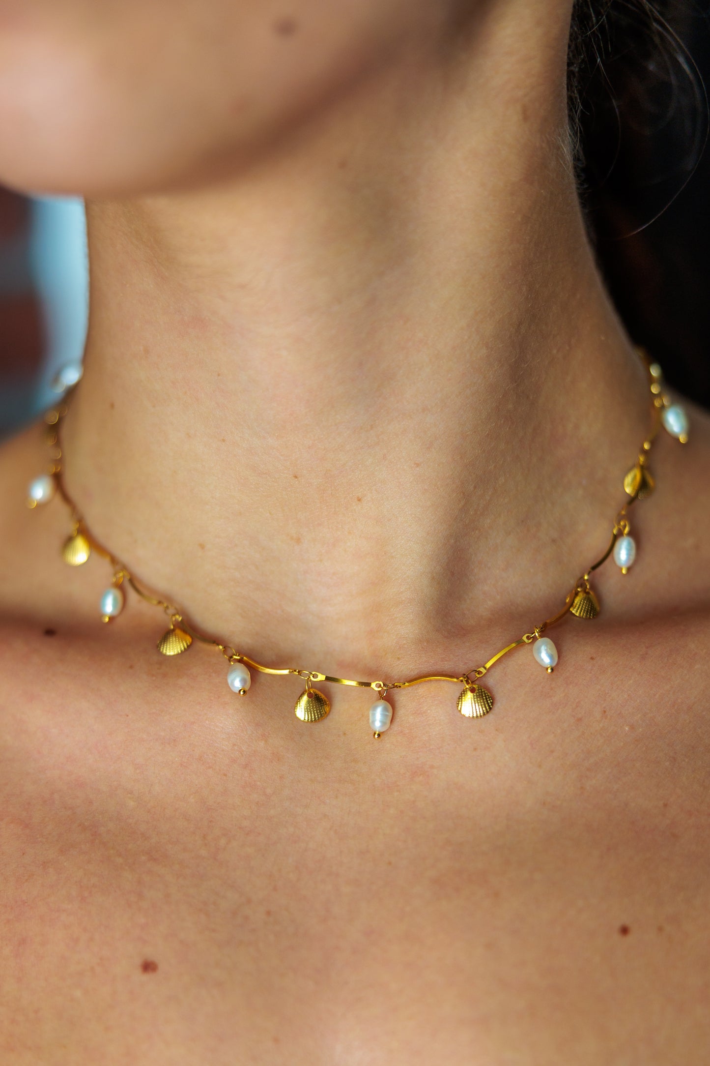 freshwater pearls and shell charms on a stainless steel chain