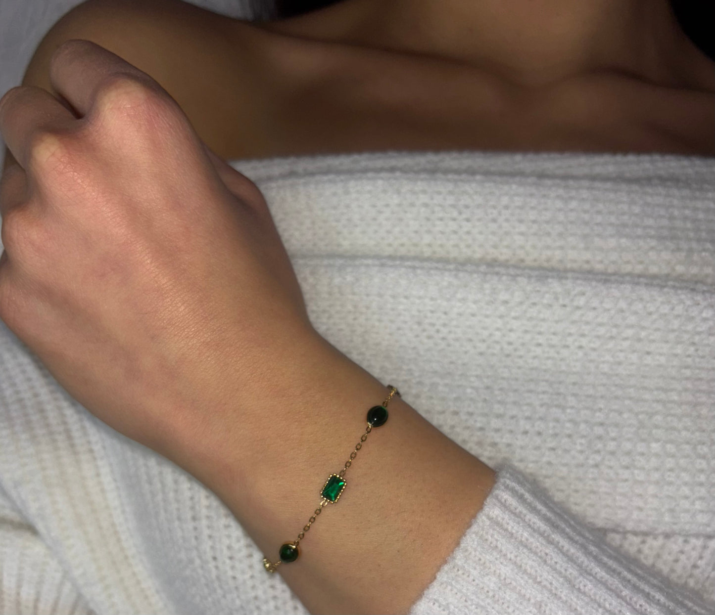 “Elegant and timeless, this 18k gold-plated bracelet features a stunning green emerald zircon centerpiece, accompanied by two matching green accents for added charm.