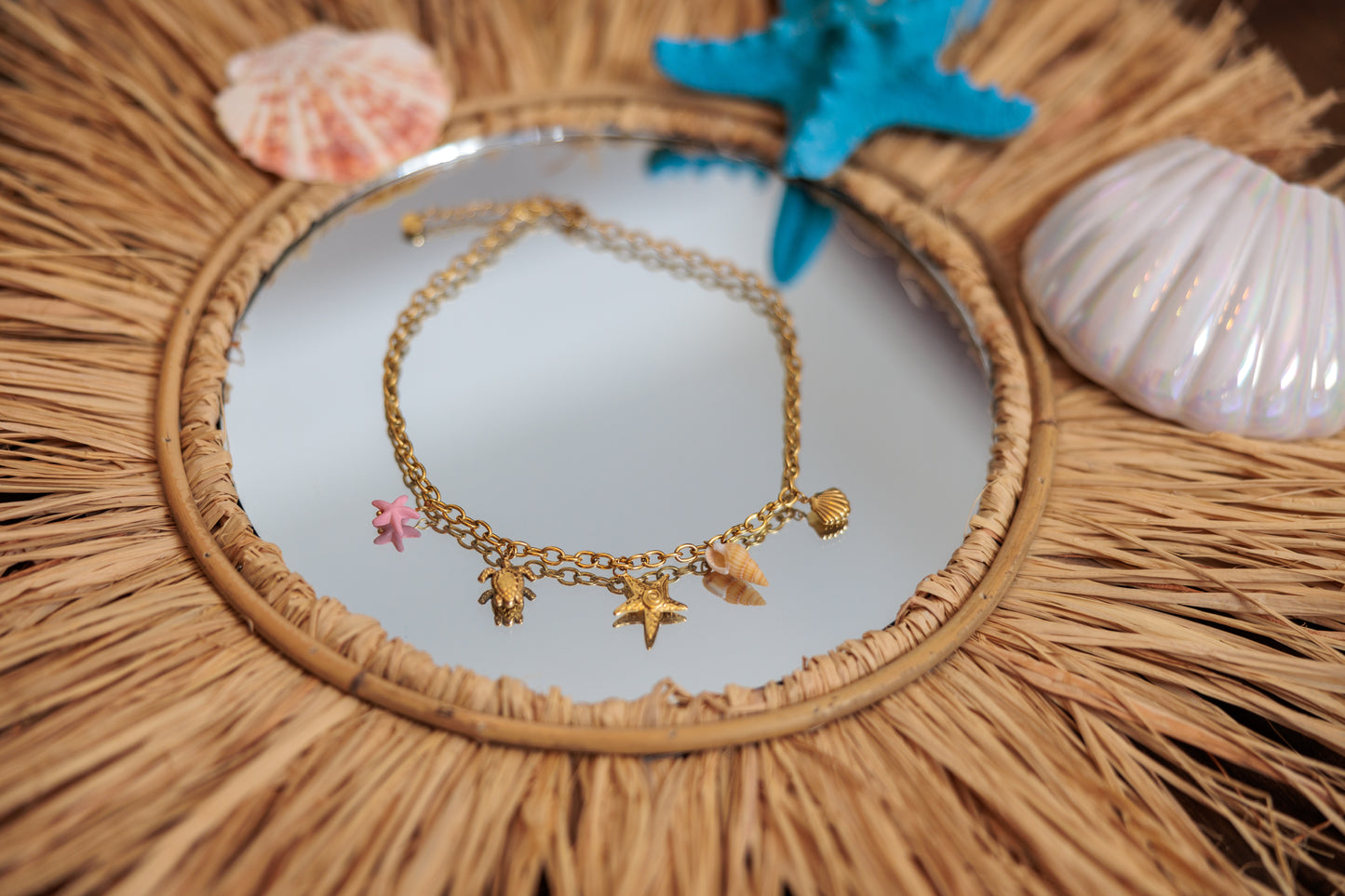 necklace withocean charms — starfish, turtle, shell, and small beads.