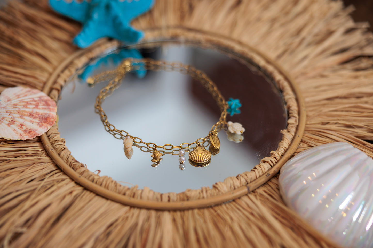 necklace with playful beach charms — shells, bluestarfish